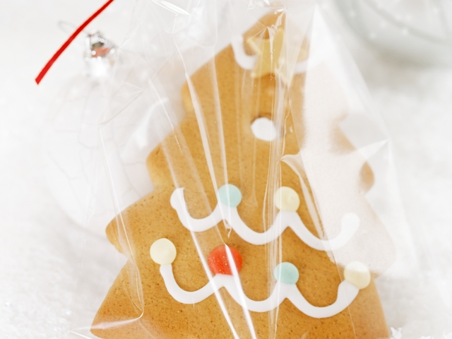 Gingerbread tree cookie in a bag on white  snow background, nice postcard